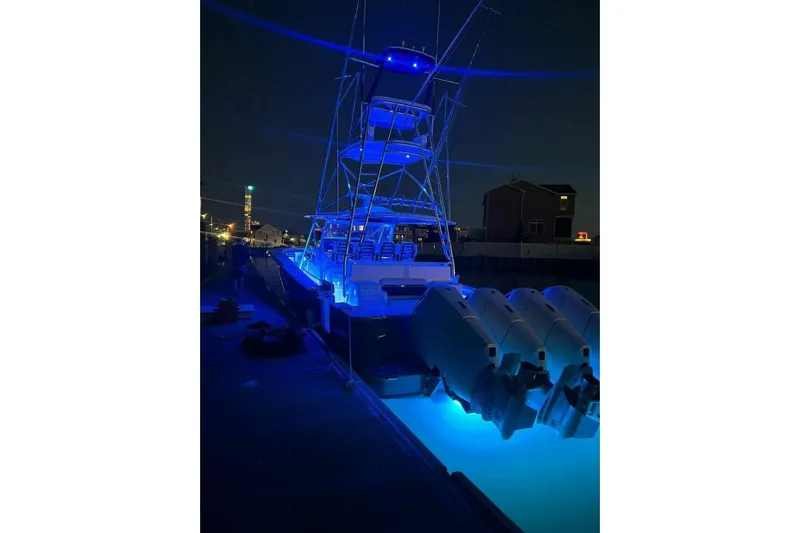  Yacht Photos Pics 2024 Valhalla Boatworks V-55 illuminated at night with blue lights.