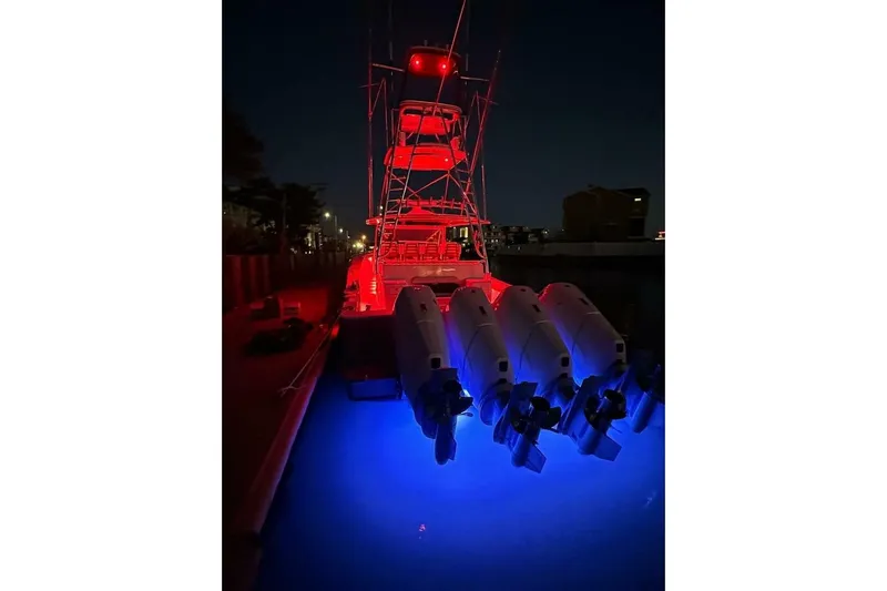  Yacht Photos Pics 2024 Valhalla Boatworks V-55 illuminated at night with red and blue lights.