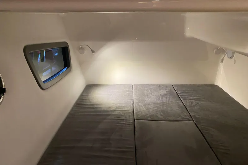  Yacht Photos Pics Interior cabin of 2026 Hanover 375 with cushioned bed and window view.