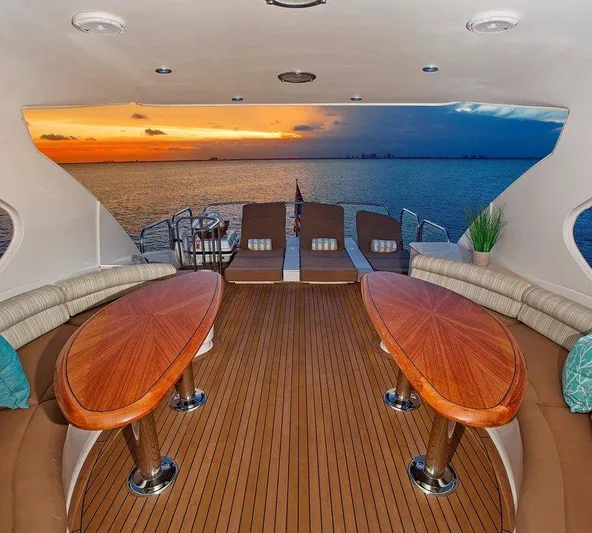  Yacht Photos Pics Luxurious 2007 Lazzara 68 yacht interior with sunset ocean view, featuring elegant wooden tables and seating.