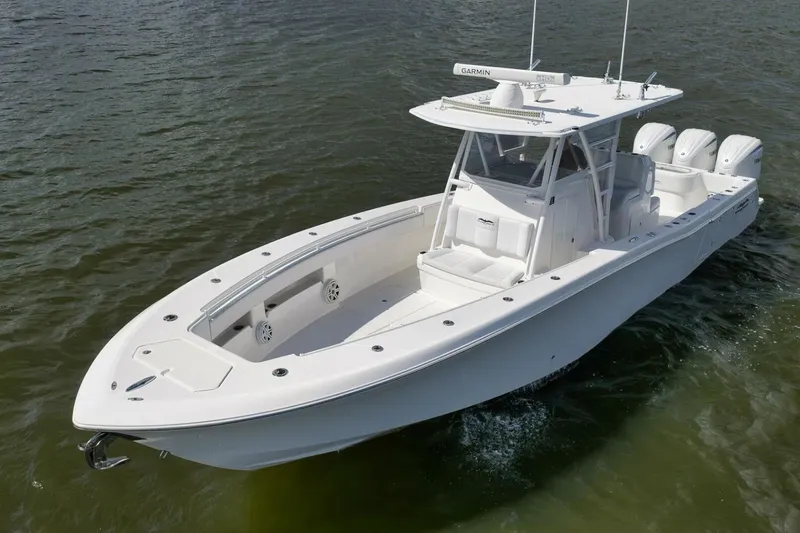  Yacht Photos Pics 2018 Invincible 36' Open Fisherman boat on water, featuring sleek design and triple engines.