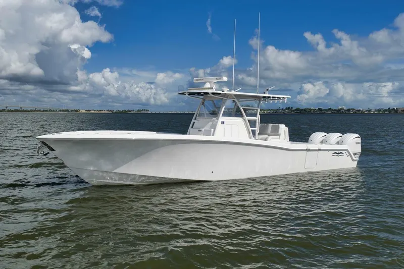  Yacht Photos Pics 2018 Invincible 36' Open Fisherman boat on calm water under a cloudy sky.