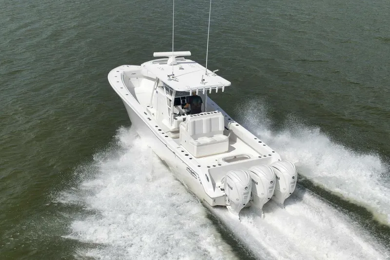  Yacht Photos Pics 2018 Invincible 36' Open Fisherman boat cruising on water with four engines.