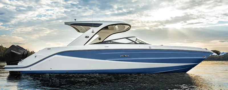  Yacht Photos Pics 2023 Sea Ray SLX310 boat on water at sunset, showcasing sleek design and luxury features.