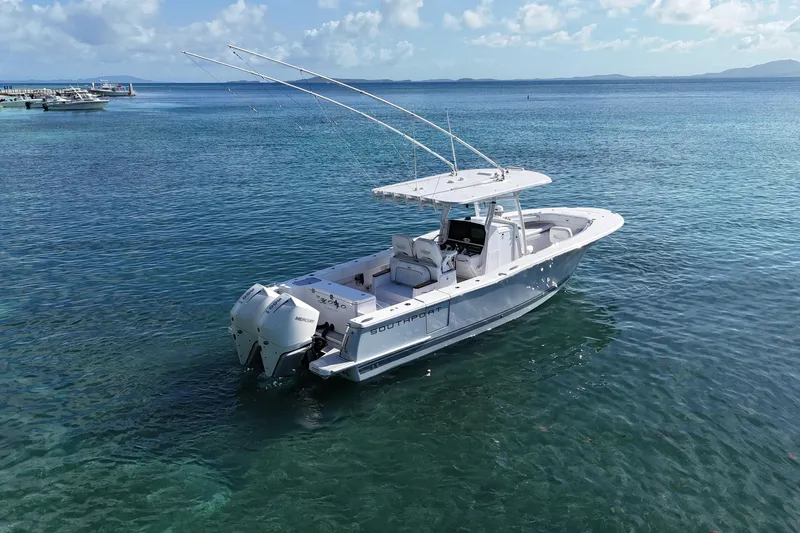  Yacht Photos Pics 2024 Southport 30 FE boat on clear blue water, featuring dual engines and fishing rods.