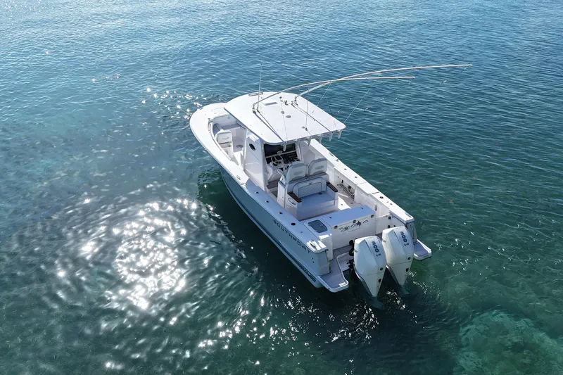  Yacht Photos Pics 2024 Southport 30 FE boat on clear blue water, featuring dual engines and spacious deck.