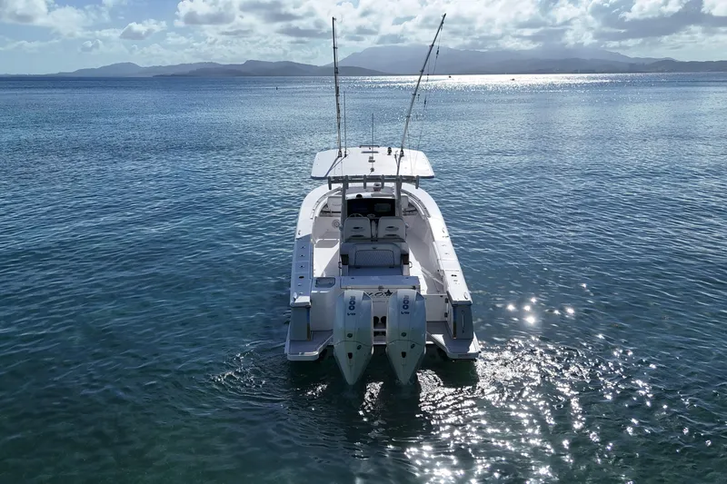  Yacht Photos Pics 2024 Southport 30 FE boat on calm ocean waters under a cloudy sky.