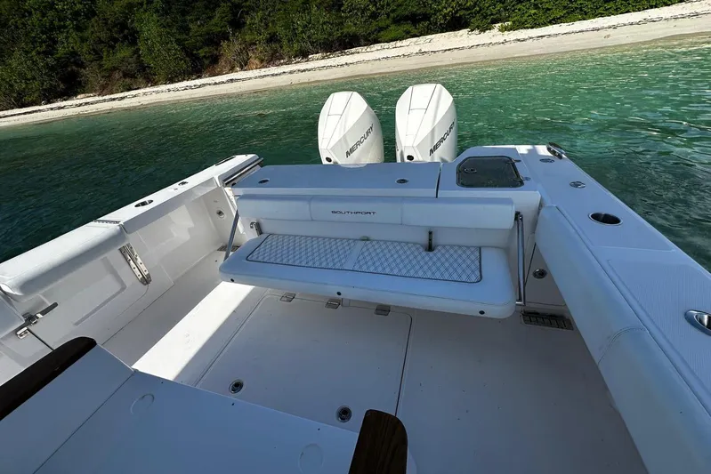  Yacht Photos Pics 2024 Southport 30 FE boat with dual engines, docked near a sandy beach.