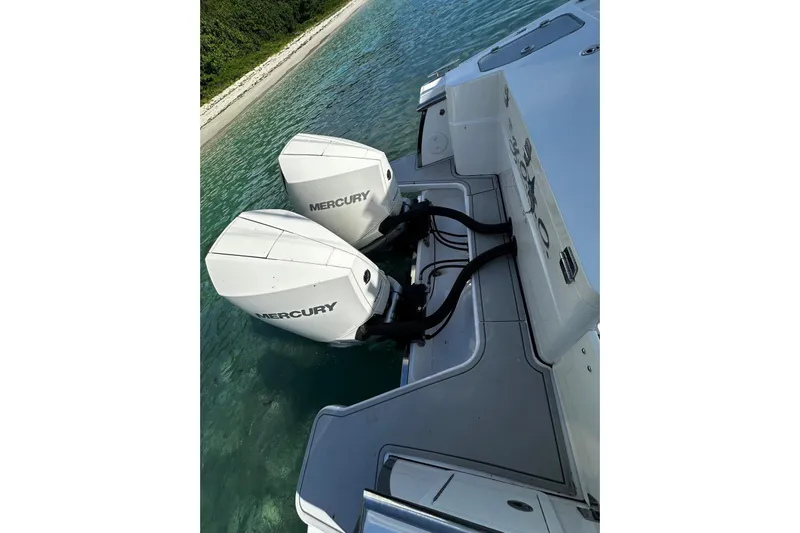  Yacht Photos Pics 2024 Southport 30 FE boat with dual Mercury outboard engines on clear water.