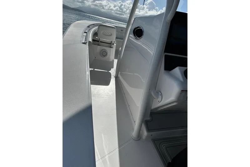  Yacht Photos Pics 2024 Southport 30 FE boat deck with seating, ocean view, and clear skies.