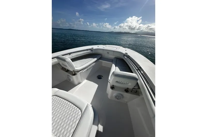  Yacht Photos Pics 2024 Southport 30 FE boat interior with cushioned seating, ocean view, and clear sky.