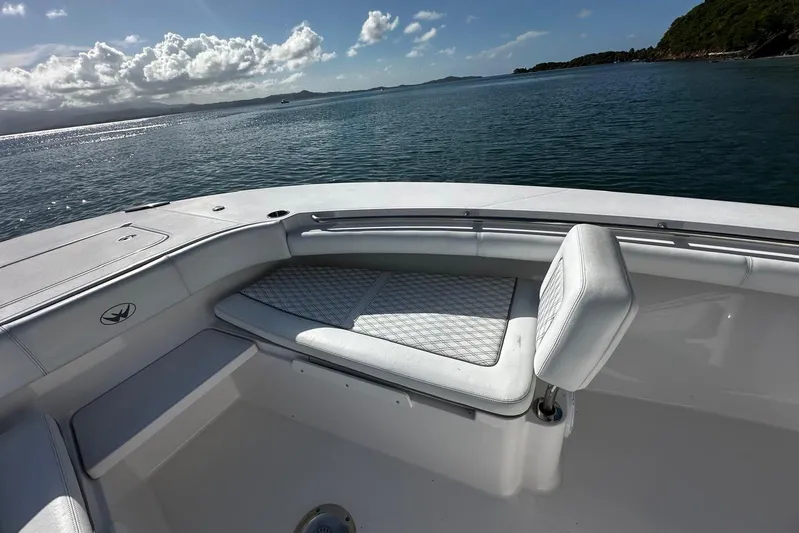  Yacht Photos Pics 2024 Southport 30 FE boat interior with cushioned seating, overlooking calm ocean waters.