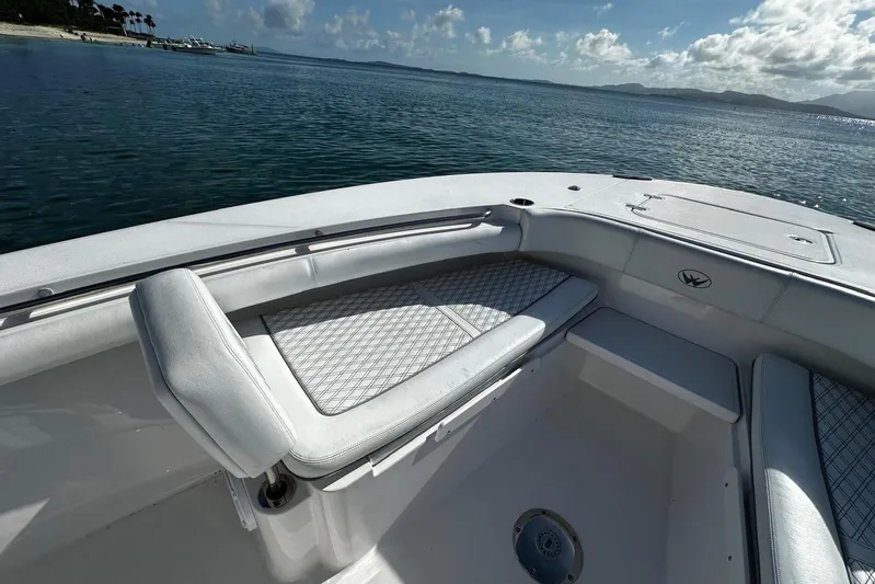  Yacht Photos Pics 2024 Southport 30 FE boat interior with cushioned seating, overlooking calm waters.