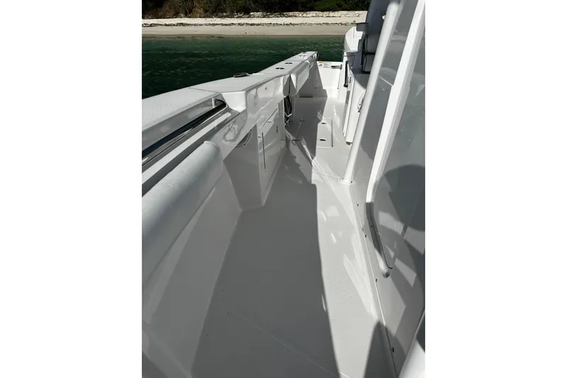  Yacht Photos Pics 2024 Southport 30 FE boat deck with sleek white design near shoreline.