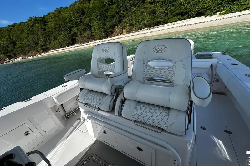  Yacht Photos Pics 2024 Southport 30 FE boat interior with luxurious seating near a scenic shoreline.
