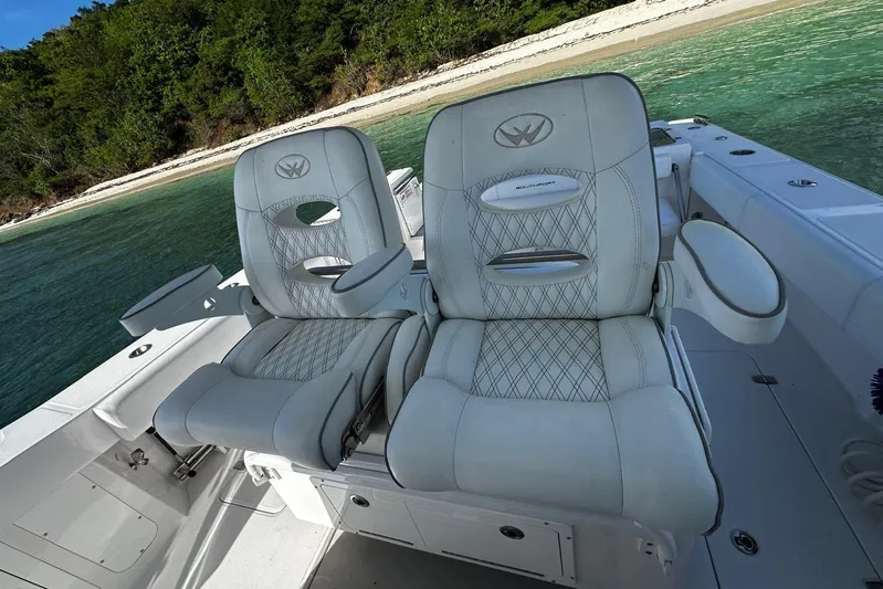 Yacht Photos Pics 2024 Southport 30 FE boat seats with luxurious design near a scenic shoreline.