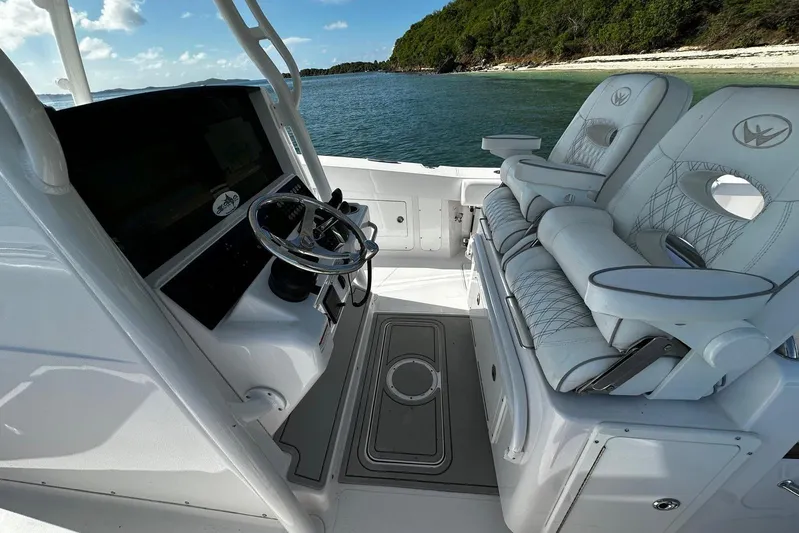  Yacht Photos Pics 2024 Southport 30 FE boat interior with steering wheel and luxurious seating.