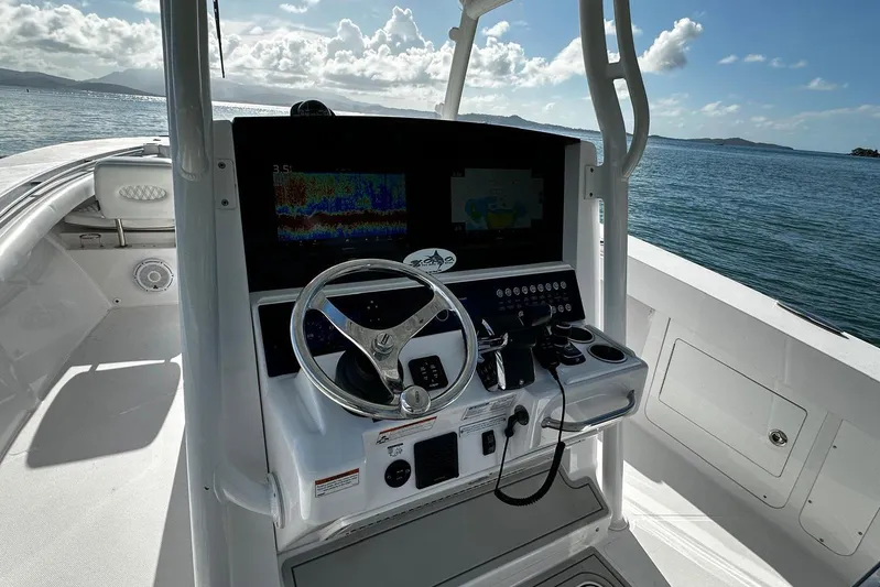  Yacht Photos Pics 2024 Southport 30 FE boat helm with steering wheel and navigation display on open water.