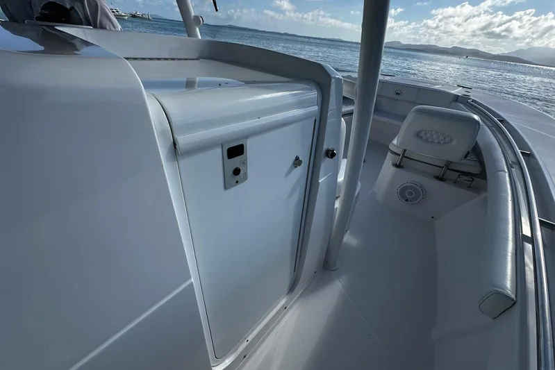  Yacht Photos Pics 2024 Southport 30 FE boat interior with seating and storage, overlooking calm waters.