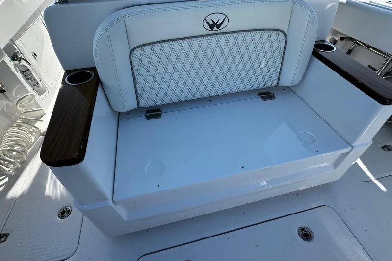 Yacht Photos Pics 2024 Southport 30 FE boat seating with cup holders and diamond-patterned upholstery.