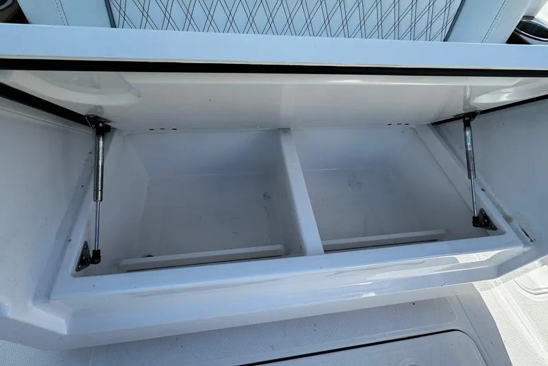  Yacht Photos Pics Open storage compartment on 2024 Southport 30 FE boat, featuring dual hydraulic supports.