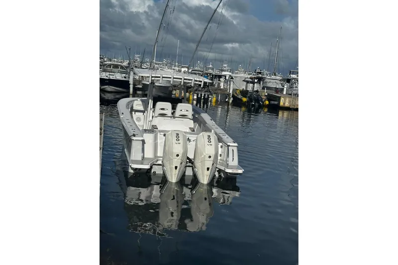  Yacht Photos Pics 2024 Southport 30 FE boat docked with twin outboard engines, reflecting on calm water.