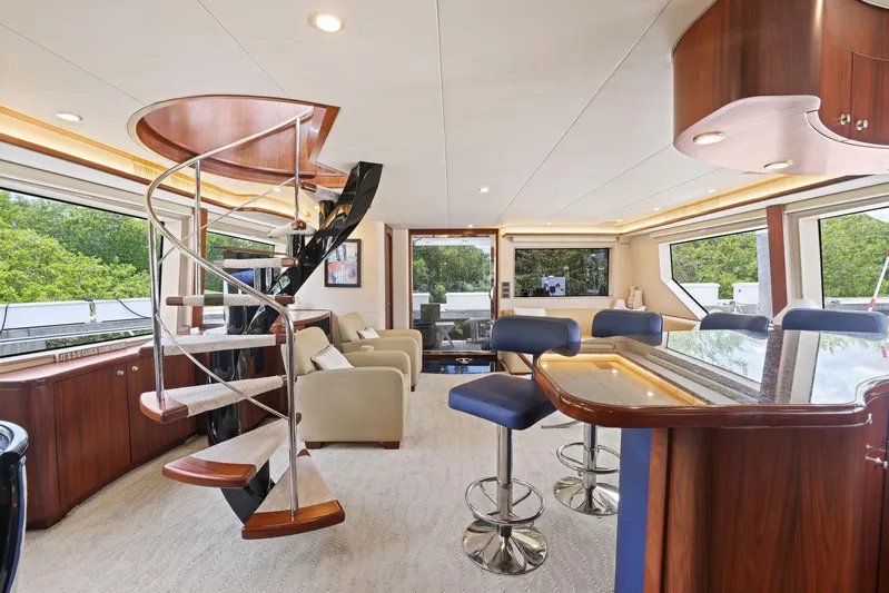 Party's Over Yacht Photos Pics Luxurious 2006 Northstar Enclosed Flybridge interior with spiral staircase and modern seating.