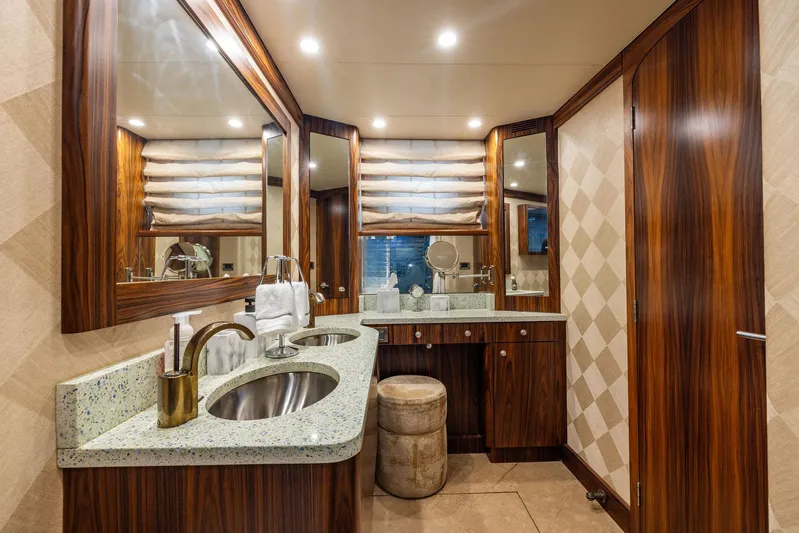 Party's Over Yacht Photos Pics Luxurious bathroom in 2006 Northstar Enclosed Flybridge yacht with dual sinks and elegant wood finishes.