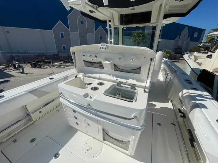  Yacht Photos Pics 2013 Boston Whaler 320 Outrage boat interior with fishing station and storage compartments.