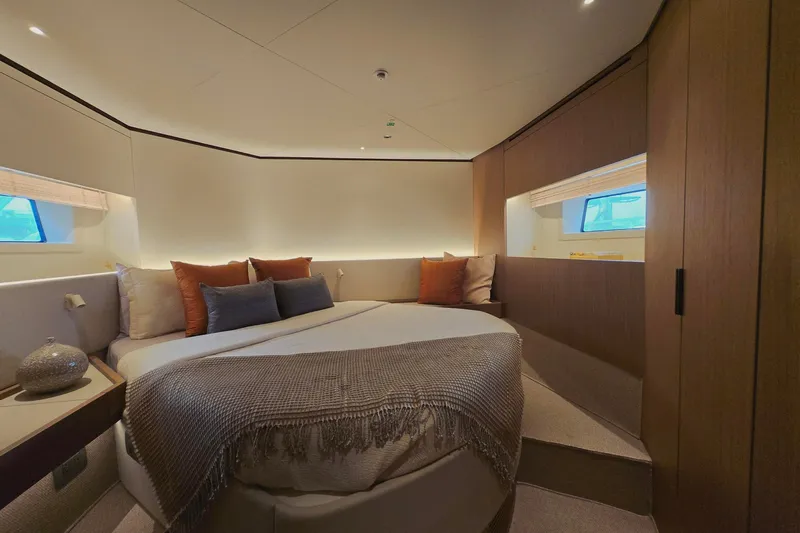  Yacht Photos Pics Luxurious bedroom interior of 2025 Azimut Seadeck 7 yacht with elegant decor and cozy bedding.