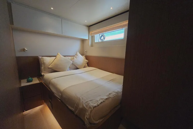  Yacht Photos Pics Luxurious bedroom interior of 2025 Azimut Seadeck 7 yacht with cozy bedding and modern design.