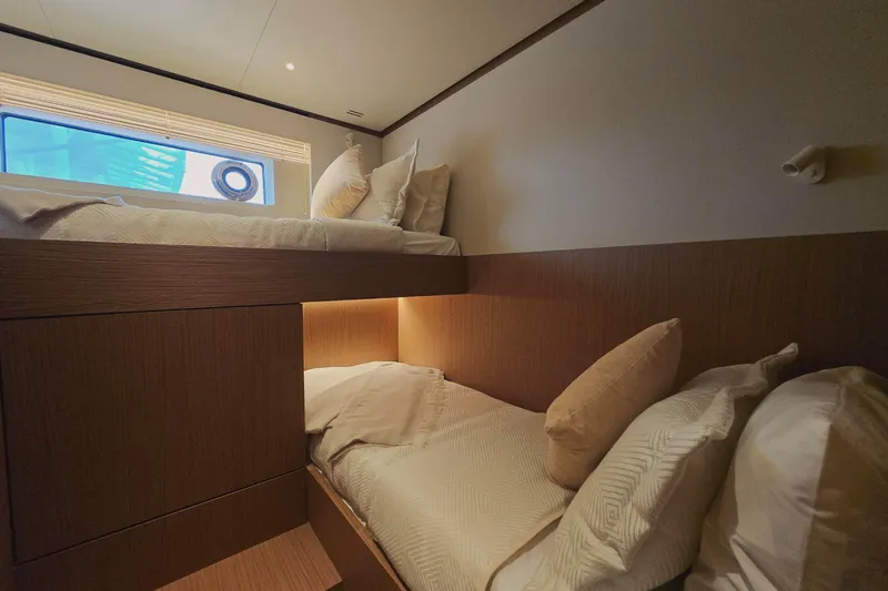  Yacht Photos Pics Interior of 2025 Azimut Seadeck 7 yacht with cozy bunk beds and window view.