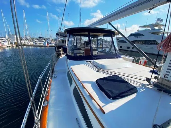 Patience Yacht Photos Pics 1989 Irwin 54 yacht docked at marina, featuring spacious deck and clear blue sky.