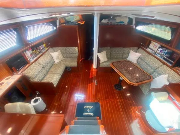 Patience Yacht Photos Pics Luxurious interior of a 1989 Irwin 54 yacht with elegant wood finishes and comfortable seating.