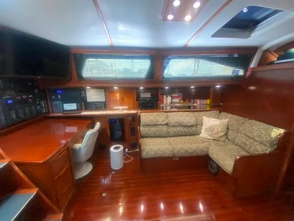 Patience Yacht Photos Pics Interior of 1989 Irwin 54 yacht with wood finish, desk, and seating area.