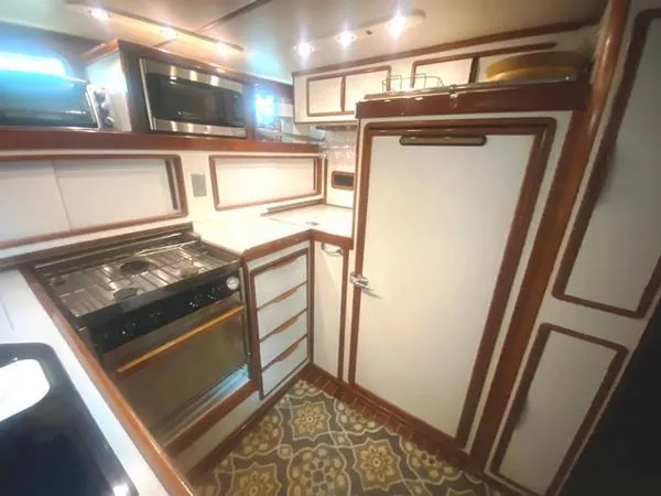 Patience Yacht Photos Pics 1989 Irwin 54 yacht kitchen with modern appliances and stylish wood trim.