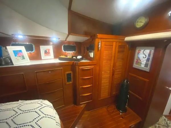 Patience Yacht Photos Pics Luxurious wooden interior of 1989 Irwin 54 yacht cabin with elegant decor and storage.