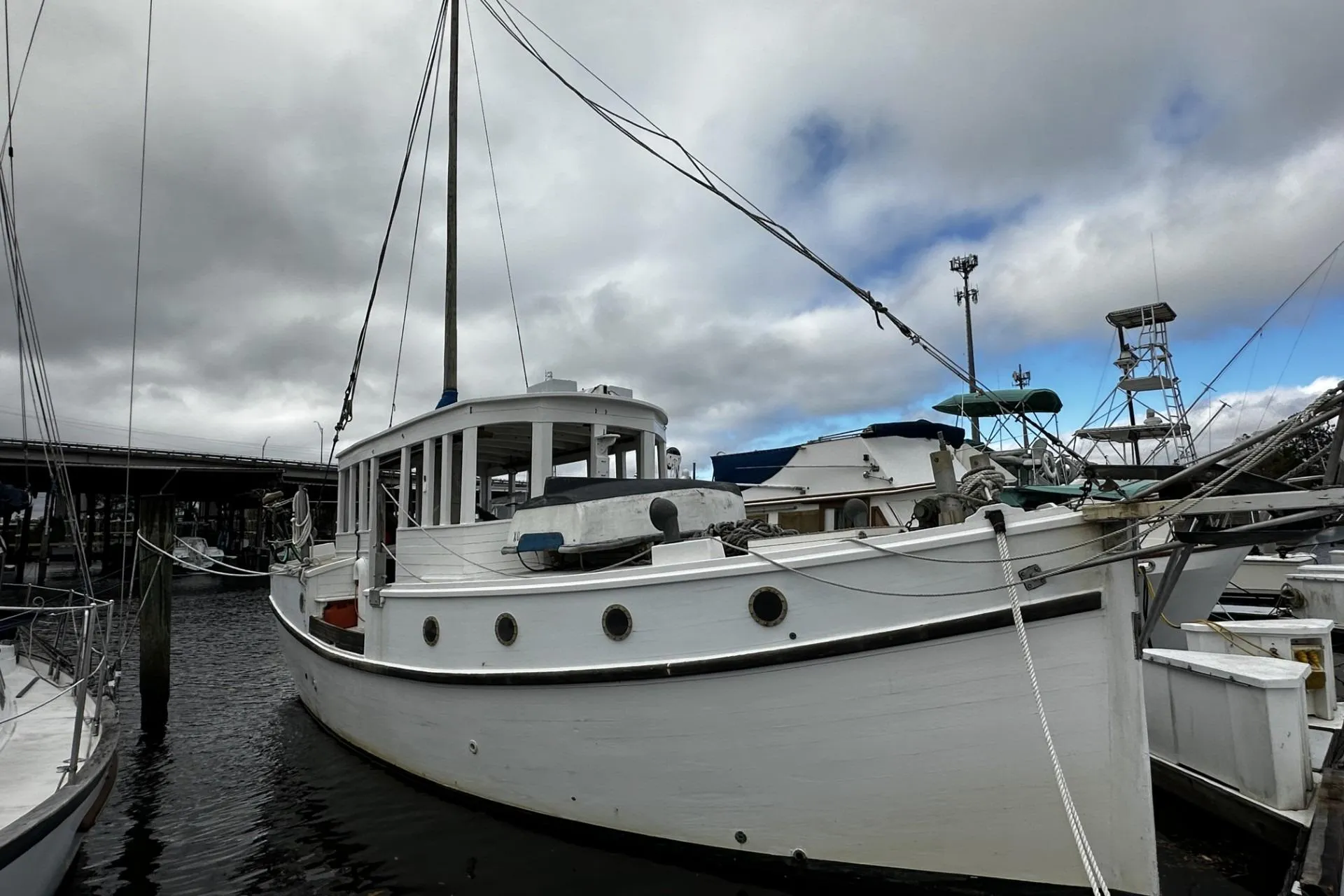 Custom 2005 sail-assisted trawler docked under cloudy skies.
