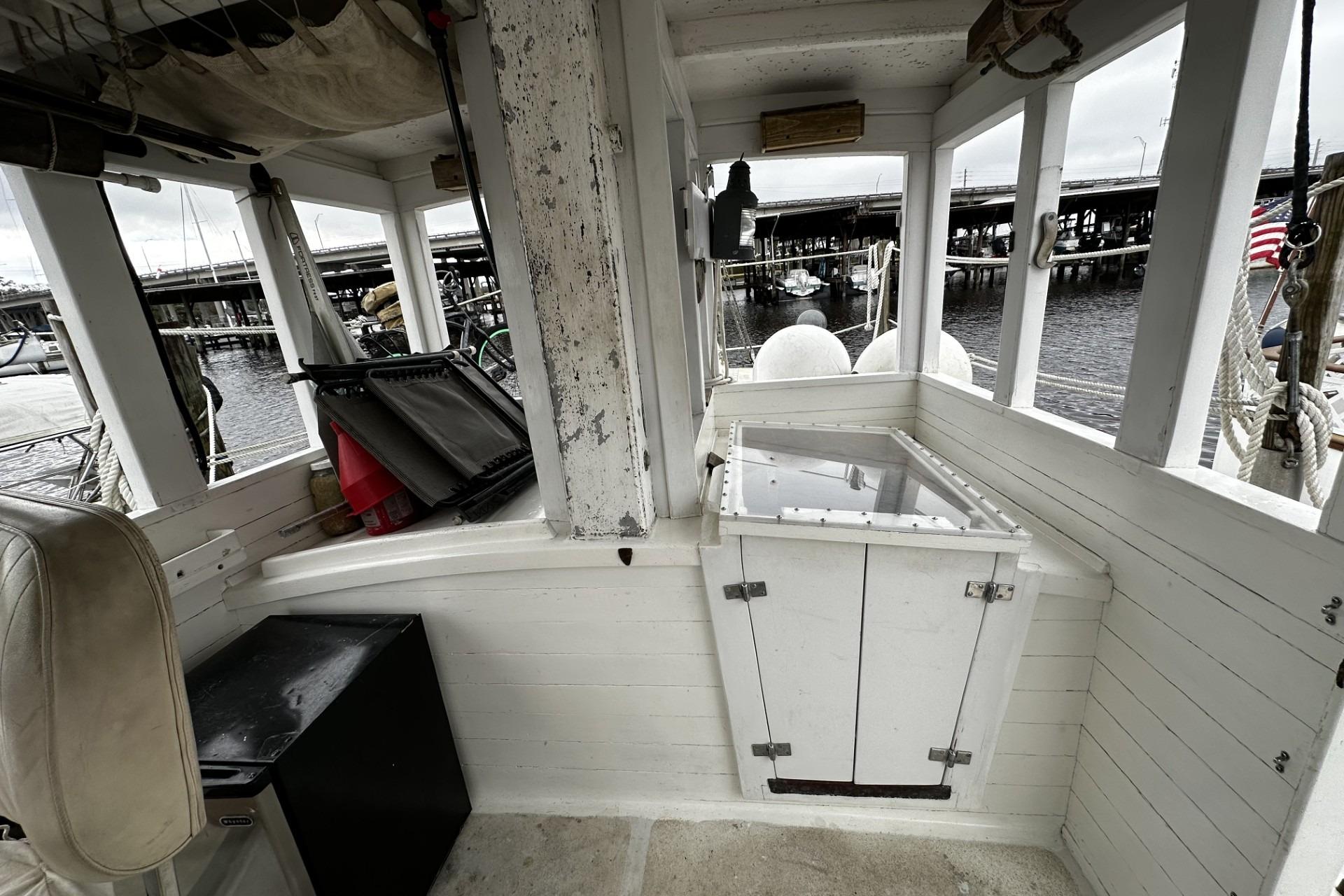 Interior of a 2005 custom sail-assisted trawler with dockside view.