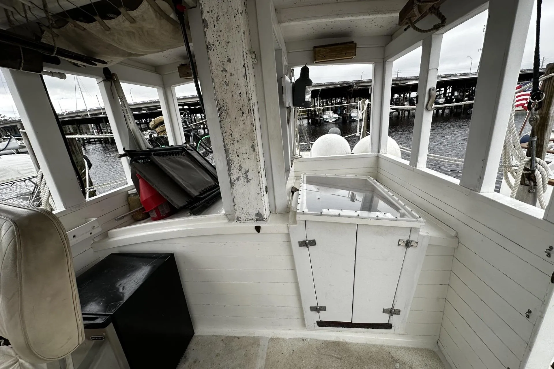 Interior of a 2005 custom sail-assisted trawler with dockside view.