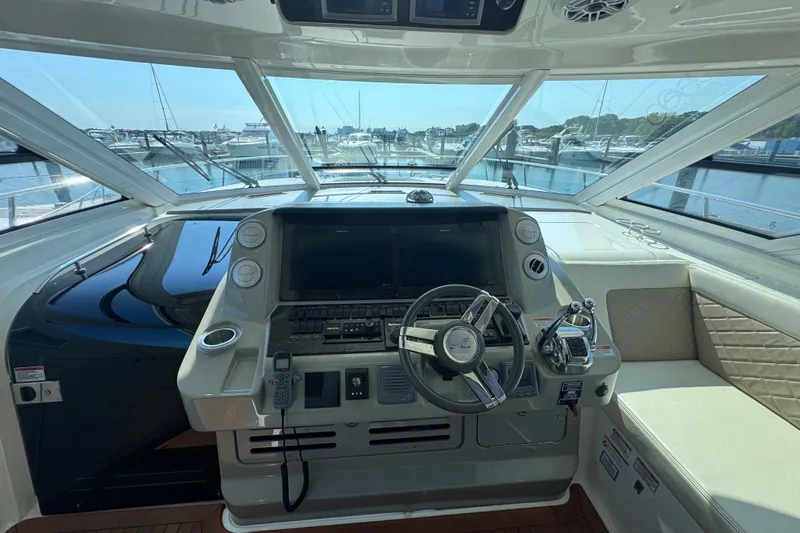 Yacht Photos Pics 2011 Sea Ray 540 Sundancer helm with steering wheel and navigation controls.
