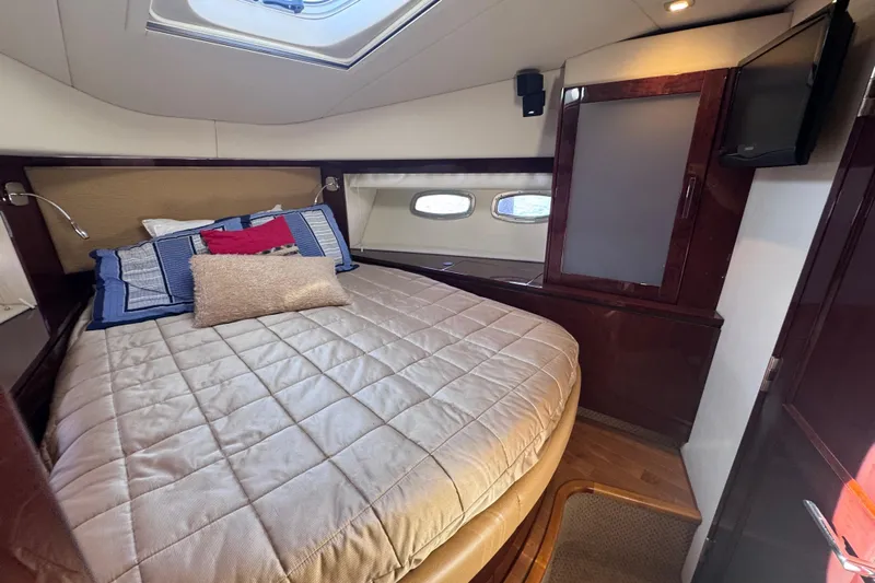  Yacht Photos Pics Luxurious cabin interior of 2011 Sea Ray 540 Sundancer yacht with cozy bed and modern decor.