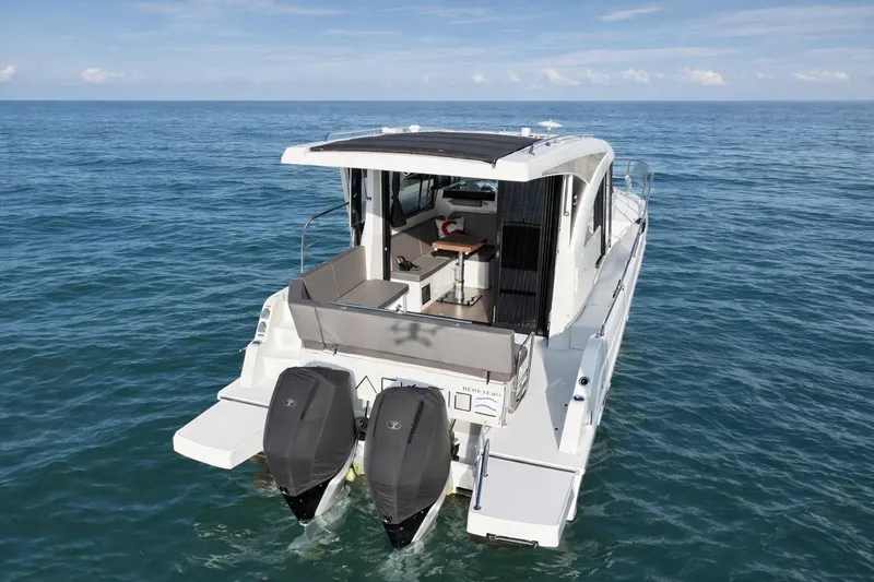 Slack Tide Yacht Photos Pics 2022 Beneteau Antares 11 Coupe boat on open water, rear view with twin engines.