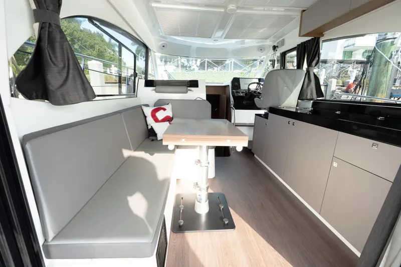 Slack Tide Yacht Photos Pics Interior of 2022 Beneteau Antares 11 Coupe, featuring modern seating and sleek cabinetry.