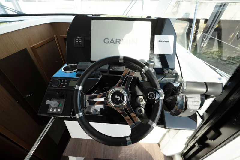 Slack Tide Yacht Photos Pics 2022 Beneteau Antares 11 Coupe helm with Garmin navigation and Mercury controls.
