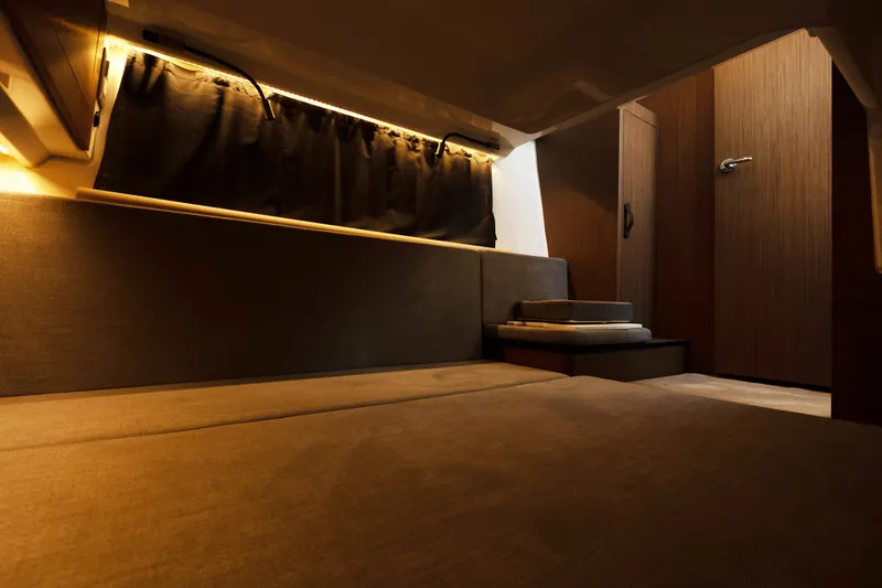 Slack Tide Yacht Photos Pics 2022 Beneteau Antares 11 Coupe interior cabin with cozy lighting and modern design.