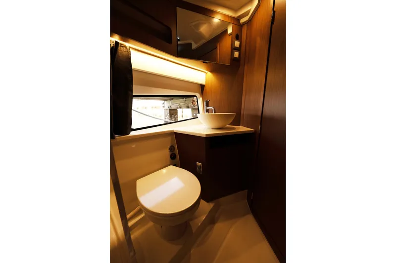 Slack Tide Yacht Photos Pics Luxurious bathroom in 2022 Beneteau Antares 11 Coupe yacht, featuring modern fixtures and elegant design.