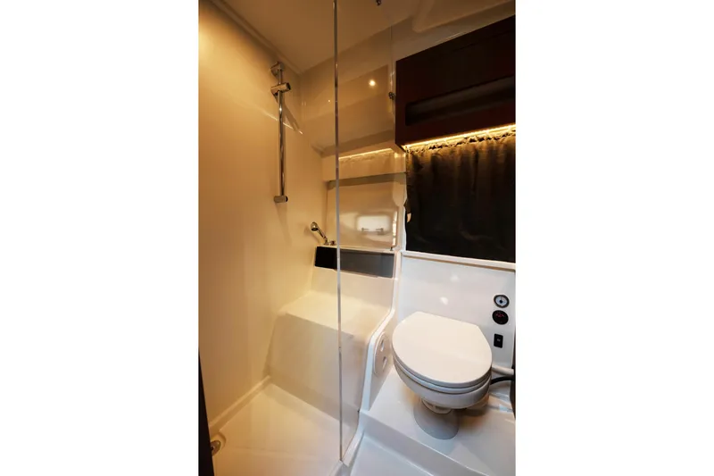 Slack Tide Yacht Photos Pics Bathroom interior of 2022 Beneteau Antares 11 Coupe, featuring modern shower and toilet.