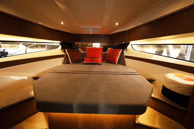 Slack Tide Yacht Photos Pics Luxurious interior cabin of 2022 Beneteau Antares 11 Coupe with elegant bedding and ambient lighting.
