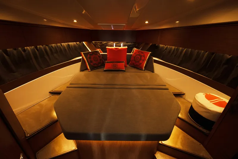 Slack Tide Yacht Photos Pics Luxurious interior of 2022 Beneteau Antares 11 Coupe with elegant bedding and ambient lighting.